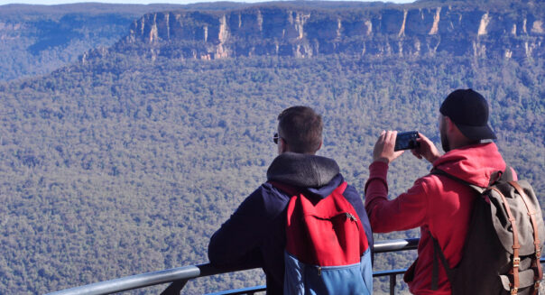 Twee mannelijke toeristen maken foto's in de Blue Mountains bij een uitzichtpunt