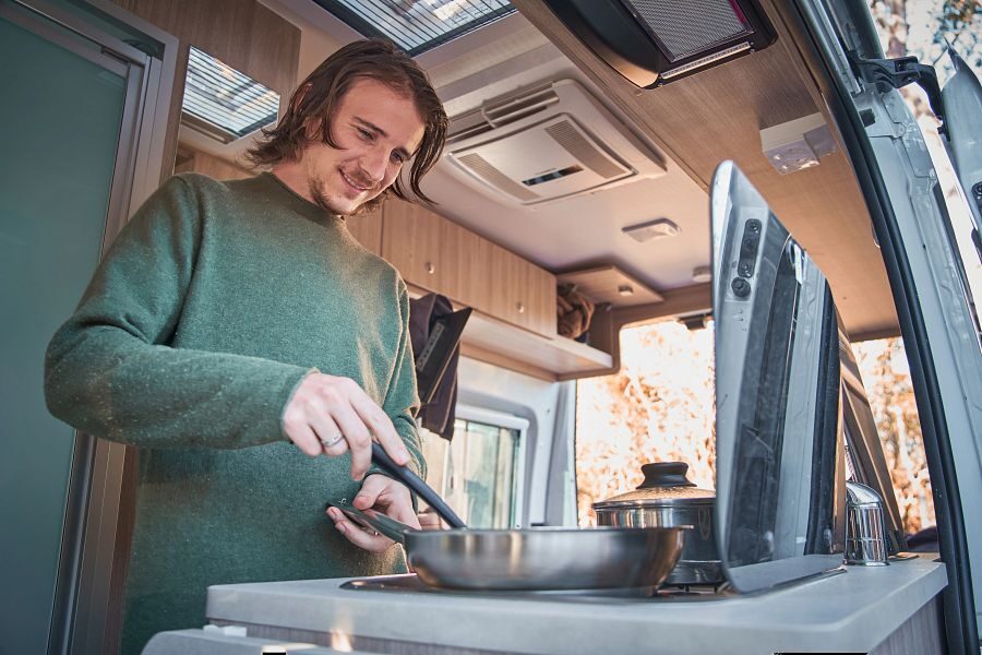 Britz Trailblazer Australië man aan het koken in de camper