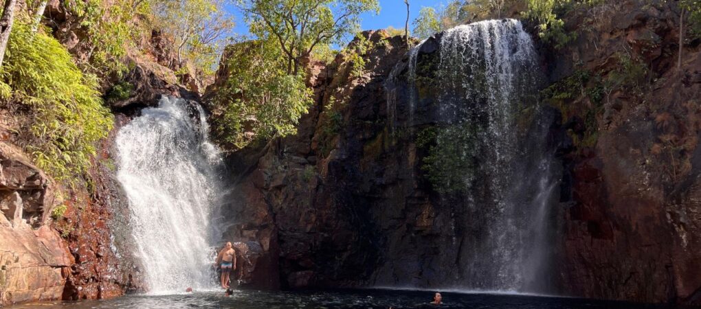 Mensen zwemmen in de waterpoel bij de Florence Falls in Litchfield